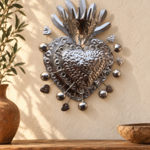 Handmade silver tin crowned sacred heart wall decor in a warm MexRoots-style home