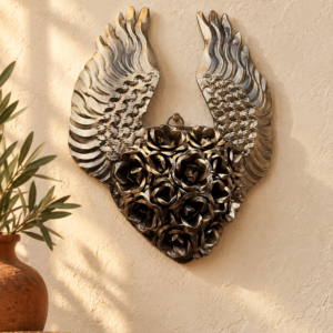 Handmade bronze floral winged tin heart wall decor in a warm MexRoots-style home